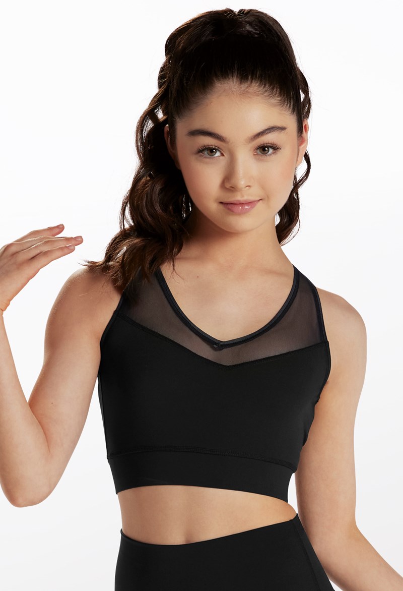 Woman in sports bra and shorts holding chain around her neck loo Stock  Photo